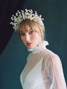 A breathtaking display of blossoms, this classic bridal crown is truly a masterpiece. Featuring an ethereal halo of ivory clay flowers with Swarovski pearl accents, this captivating piece is made for a bride with impeccable style. Erin Rhyne is known for ornate high-end headpieces that combine botanical realism and romantic designs. Each piece is an alluring creation of texture, color, and refined execution rendering dramatic and luxurious accessories. Pearl Bridal Headband, Ivory Flowers, Floral Headpiece, Be Natural, Bridal Crown, Headpiece Wedding, Clay Flowers, Floral Headbands, Bridal Headband