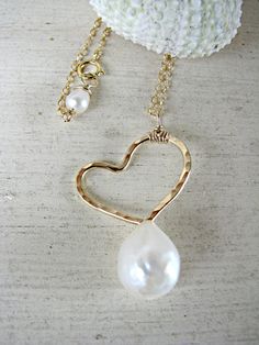 "This hand-formed and hand-hammered 14k gold-filled artistic heart pendant features a beautiful 9mm-10mm white freshwater Keishi* pearl below and a sweet tiny white freshwater pearl at the clasp of the 14k gold-filled chain. You may choose between Sterling Silver ($55) and 14k Gold-Filled ($65-Shown) and also a custom chain length (between 15\"-20\") at checkout. *This is a Keishi pearl, which has a more organic shape that features a more-rounded front side and a flatter back side. This heart sh Wedding Pearl Jewelry With Heart Charm, Pearl Jewelry With Heart Charm For Wedding, Pearl Heart Charm Jewelry For Wedding, Wedding Pearl Charm Heart Pendant Jewelry, Pearl Pendant Jewelry For Wedding, Heart-shaped Pearl Drop Jewelry For Anniversary, Valentine's Day Wedding Pearl Pendant Jewelry, Elegant Handmade Heart Necklace For Wedding, Dainty Heart Necklace With Pearl Charm For Wedding