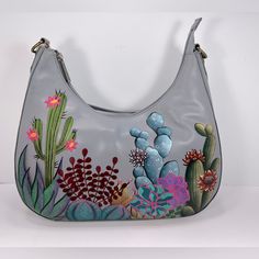 Gorgeous! Anuschka Hand Painted Leather Hobo Style Shoulder Bag With Southwest Garden Art Work. Anuschka Means "Like No Other" And Each Bag Is Truly A One-Of-A-Kind Wearable Work Of Art. You Will Receive Compliment After Compliment When You Carry This Bag. Details: Hand Painted Original Artwork By Master Artisans. Beautiful Embroidered Accents (See Photos). Size/Profile: Hobo Walls - Top Grain Hand-Painted Leather; Signature Logo; Embroidered Finish. Handles/Strap - Attached Shoulder Strap With Southwest Garden, Hand Painted Leather Bag, Painted Leather Bag, Painted Gifts, Hand Painted Purses, Flamingo Bag, Cat Handbags, Painted Purse, Soft Leather Purse