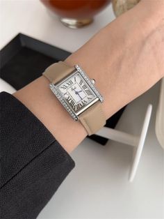 This watch features a sleek square dial with bold Roman numerals 🕰️, framed by shimmering crystals 💎. Paired with a beige leather strap, it combines classic elegance with modern sophistication. Material: stainless steel, glass, Genuine Leather Dimensions: Case Width: 20mm  Case Length: 23mm Case Height: 8mm Band Width: 16mm Band Length: 22cm Packaging: Each watch comes in a beautiful gift box. 🎁  NOTICE:  If the product is damaged or defective, please take a clear picture and send it to us. W Trendy Rectangular Quartz Watch, Trendy Formal Watch With Rectangular Dial, Trendy Rectangular Watches With Leather Strap, Trendy Rectangular Watch With Leather Strap, Luxury Square Everyday Watch, Elegant Square Watches With Diamond Hour Markers, Leather Band Watches, Minimalist Women, Square Face