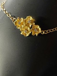 Four tiny gold plated flowers will adorn your wrist, and they'll complement your outfit. If you want to show a friend how much you appreciate her, you found the perfect gift.  The little flowers are made of gold plated and CZ, and the rest of the bracelet is gold filled. Please let me know your size. Formal Gold Jewelry With Flower Charm, Dainty Yellow Gold Bracelet With Flower Charm, Dainty Gold Flower Jewelry, Delicate Gold Bracelets With Flower Charm, Delicate Gold Bracelet With Flower Charm, Gold Bracelets With Flower Charm For Wedding, Gold Wedding Bracelets With Flower Charm, Gold Flower-shaped Bracelets For Party, Dainty Gold Flower Shaped Bracelets