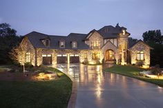 a large house lit up at night with lights on