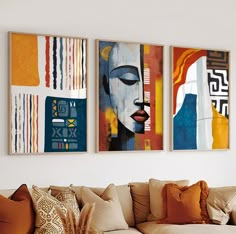 three abstract paintings hang on the wall above a couch in a living room with pillows