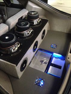 the inside of a car with speakers and other electronics in it's center console