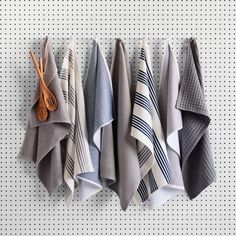 five folded towels hanging on a wall