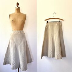 1950s woven satin skirt neutral beige, perhaps a slip or layering skirt cut with a flare with v-shaped back insert back metal zipper closure good vintage condition- overall light wear  Approx size Small Measurements waist- 25/26 inches hips-  44 inches  length- 28 inches era 50s label- n/a Vintage Full Skirt In Beige, Vintage Full Skirt Bottoms In Beige, Vintage Beige Full Skirt Bottoms, Vintage Style Lined Beige Skirt, Vintage Beige Flared Skirt Bottoms, Vintage Beige Flared Skirt, Vintage Beige Lined Skirt, 1950s Skirt, 1950s Hat