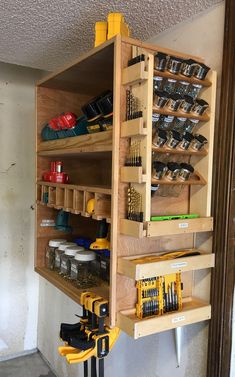 a workbench with tools and other items on the shelves in front of it