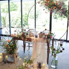 the table is set with flowers and candles