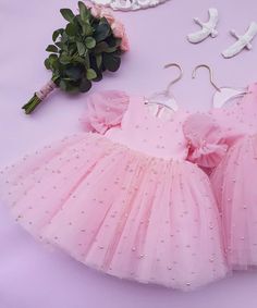 This beautiful pink pearl tulle dress is best birthday dress for your angel. Pink tulle decorated with pearls. Backside Big pink bow (can adjustable) Fluffy skirt with few layers of tulle. We have limited sized available and If you want to customized please send us a direct message. (Custom orders will ready within 3 to 4 weeks) Pink Tulle Tutu Dress For Wedding, Princess Style Organza Tutu Dress For Baptism, Princess Style Pink Bow Tutu Dress For Party, Princess Tutu Dress With Pink Bow For Party, Princess Style Party Tutu Dress With Pink Bow, Pink Organza Tutu Dress For Baptism, Elegant First Birthday Tulle Tutu Dress, Party Princess Dress With Pink Bow, Sweet Tulle Princess Dress For Party