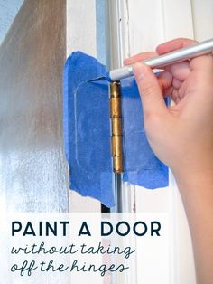 a person is cleaning the door with a blue cloth and a metal pole in front of them