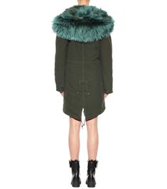 Cosy up in Mr & Mrs Italy's exquisite fur-lined parka this season for the warmest, most luxe way to fend off the chill. The deep green hue is set off with a plush, voluminous fur-trimmed hood with brighter green highlights. The fur lining promises a plush feeling that will prove its worth when you're walking in the snowy city. Size XS material: 100% cotton material II: 100% lamb leather fur: 100% raccoon fur lining: 100% coyote fur sleeve lining: 65% polyester, 20% acetate, 15% viscose care Snowy City, Green Parka, Coyote Fur, Green Highlights, Mr And Mrs, The Deep, Deep Green, Bright Green, Cotton Material