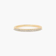 a yellow gold band with white diamonds on the inside and outside, set against a plain background