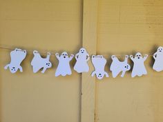 paper cut out ghost buntings hanging on a line