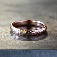 This hammered gold ring has a timeless style that will last for generations, perfect for a wedding band. The band is 4mm in width and 2mm thick, comfort fit, and available in either 14k rose gold (as shown in the photos) or 14k yellow gold. The exterior is hammered with a faceted pattern to create shimmering details, while the interior remains smooth. This is a striking and simple ring, perfect for everyday wear. Anniversary Rose Gold Hammered Stackable Rings, Hammered Rose Gold Stackable Rings For Wedding, Wedding Stackable Hammered Rose Gold Rings, Wedding Hammered Rose Gold Stackable Rings, Classic Hammered Stackable Wedding Rings, Hammered Rose Gold Round Band Jewelry, Rose Gold Hammered Round Band Jewelry, Rose Gold Hammered Wedding Rings, Elegant Hammered Bands For Anniversary