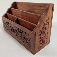 a wooden box with three compartments on it