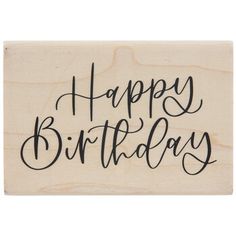 a wooden stamp with the words happy birthday on it