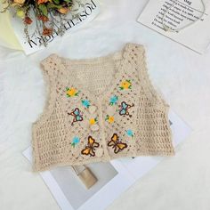 Cute Sleeveless Crochet Cotton Top, Casual Sleeveless Crochet Top With Floral Embroidery, Sleeveless Casual Crochet Top With Floral Embroidery, Sleeveless Crochet Top With Floral Embroidery For Beach, Floral Embroidery Sleeveless Crochet Top For Beach, Floral Embroidered Sleeveless Crochet Top For Beach, Cute Sleeveless Crochet Top For Beach, Sleeveless Crochet Sweater Vest For Spring, Sleeveless Cotton Crochet Sweater Vest