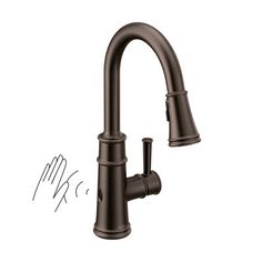 the kitchen faucet is shown in bronze