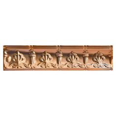 an ornately designed gold metal shelf with decorative designs