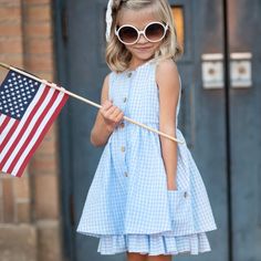 This dress is perfect for spring, Easter, and all those sunny summer days! It's got playful blue and white gingham checks, cute pockets, buttons, and even a fun ruffle under-layer. Totally adorable and oh-so-comfy for your little girl! Playful Spring Sundress For Day Out, Summer Plaid Dress With Ruffle Hem For Picnic, Blue Plaid Dress For Spring Day Out, Spring Gingham Sundress With Ruffles, Spring Blue Plaid Cotton Dress, Blue Plaid Dress For Spring Picnic, Casual Sundress For Playdate In Summer, Cute Gingham Dresses For Day Out, Picnic Gingham Sundress With Ruffles