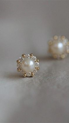 This pair has a modern twist, with a 14K gold or silver halo of alternating CZ stones and shiny beads surrounding a gorgeous faux pearl. >> Pearl CZ Halo Studs: https://pinealvisionjewelry.com/products/pearl-cz-halo-studs Elegant Pearl White Jewelry With Pearl Buttons, Elegant Pearl Earrings With Halo Design As Gift, Dainty Studs, Girl Needs, Affordable Jewelry, Christmas Gifts For Mom, Winter Outfits Women, Pretty Jewellery, Pearl Studs