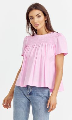 Cotton yoke blouse designed with short sleeves and pleated texture. Easy to style with any bottoms. Top Bubblegum pink Self: 100% Cotton Length: 23" Chest: 17 3/4" Hand wash in cold water. Lay flat to dry. Low iron. Model is wearing a size small Style #: G242T6942 Summer Pintuck Short Sleeve Tops, Summer Relaxed Fit Top With Pintucks, Casual Pintuck Short Sleeve Tops, Casual Short Sleeve Tops With Pintucks, Pink Smocked Back Blouse For Spring, Spring Pink Blouse With Smocked Back, Pink Blouse With Smocked Back For Spring, Cotton Smocked Short Sleeve Top For Daywear, Summer Daywear Tops With Pintucks