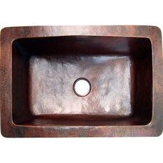 a square wooden sink with a hole in the center and an oval hole in the middle