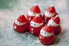 some strawberries with santa hats on them