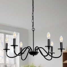 a black chandelier with five lights hanging from it