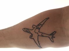 an airplane tattoo is shown on the arm