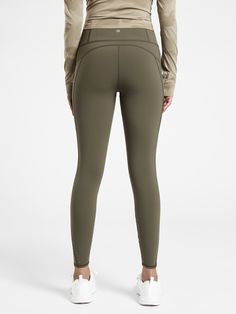 the back view of a woman in khaki green leggings