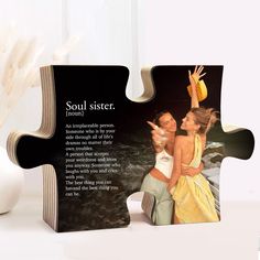 a puzzle piece with the words soul sister on it and two women in yellow dresses