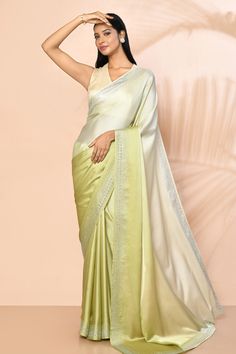 Light green ombre saree in satin base with stone embellished borders. Comes with running blouse piece.
Components: 1
Pattern: Embellished
Type Of Work: Stones
Fabric: Satin
Color: Green
Other Details: 
Length:
Saree: 5.5 mtrs
Running Blouse: 0.80 mtrs
Approx. product weight: 500 - 800 gms
Note: Stitched blouse worn by the model is not for sale
Occasion: Reception - Aza Fashions Pista Green Saree With Embroidered Border, Green Embroidered Border Saree For Reception, Green Pre-draped Saree With Embroidered Border For Wedding, Green Wedding Saree With Embroidered Border, Green Silk Blouse Piece With Embroidered Border, Pista Green Silk Pre-draped Saree For Eid, Green Pre-draped Saree With Border, Green Wedding Saree With Border, Pista Green Katan Silk Pre-draped Saree For Wedding