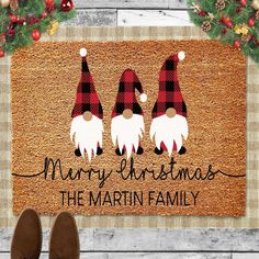 a door mat with three gnomes on it and the words merry christmas, the martin family