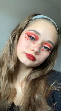 Red eyeshadow 
Red lipstick 
Red makeup
Valentines days makeup
Red hearts
Heart makeup
Fake Eyelashes 
Blush
Glowy makeup 
Vday makeup
Cut crease eyeshadow 
Red Eyeliner 
Winged eyeliner Red Hearts Makeup, Queen Of Hearts Makeup Ideas Simple, Cupid Hairstyle, Christmas Day Makeup