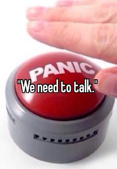 someone holding their hand up to a red button that says panic we need to talk