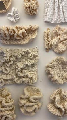 several crocheted items are displayed on a white surface