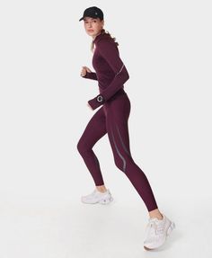 Our updated bum-sculpting run leggings, voted ‘Best Leggings’ by Women’s Running Awards. Ultra-lightweight Italian fabric is quick-drying for your sweatiest sprints. High-waisted design with an adjustable waist, a back zip pocket and two side slip pockets. Warp-knitted fabric offers compression technology, UV40+ protection and improved opacity. Reflective detailing mimics kinesiology tape for added support and compression. Inseam length: 27" / 68cm. Model wears size S and is 178cm/5'10" tall. Style Code: SB9103Colour: Midnight Cherry Purple Kinesiology Taping, Zero Gravity, Best Leggings, Sweaty Betty, Compression Leggings, Running Tights, Italian Fabric, Women's Leggings, Knitted Fabric