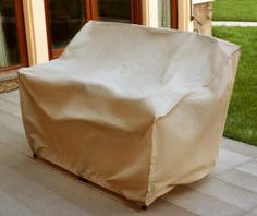 an outdoor bbq cover on the patio with grass in the back yard behind it