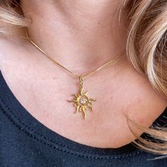 Elevate your style with our stunning 18k Gold Filled Sun Pendant. Crafted to perfection, this radiant pendant features a captivating sun design adorned with sparkling Cubic Zirconia stones. Measuring 3cm long x 2cm wide and weighing just 1.3 grams, it's both elegant and lightweight. Enjoy hypoallergenic and waterproof properties, ensuring lasting beauty and durability. Handcrafted in Brazil    Learn how to care for your jewelry with these easy instructions. Properly handling and caring for your ArtBossa jewelry is essential in maintaining its pristine condition. 1. Keep your gold-filled jewelry away from chemicals and cleaning products. Remove your jewelry when handling them to keep it in good condition. 2. To protect your jewelry, don't apply perfume directly on it. Apply fragrance to you Elegant Diamond Jewelry With Sun And Moon Design, Elegant Diamond Sun And Moon Jewelry, Elegant Sunburst Jewelry With Sun And Moon Design, Elegant Sunburst Jewelry With Sun Design, Elegant Sun And Moon Design Sunburst Jewelry, Gold Sunburst Jewelry With Sun And Moon Design, Elegant Yellow Gold Sun-shaped Jewelry, Elegant Sun-shaped Yellow Gold Jewelry, Sun Pendant