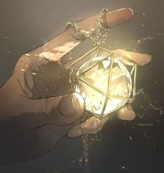 a hand holding a small diamond in it's center with the light shining through