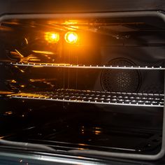 an oven with the light on and it's door open to show its bright lights