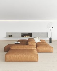 a modern living room with large leather couches