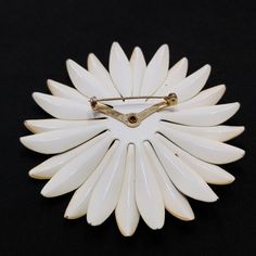 "*Description: This is a great 1960s large enamel flower brooch in two shades of beige on a white enamel over metal background with a rolling c clasp on a v rivet. The brooch has a large rounded beige button center. These flowers were very popular in the \"Flower Power\" 1960s. This would be a great brooch for a jacket, hat, or bag. This would be a great addition to your vintage jewelry collection or make a great vintage gift! *Approximate Measurements: Length & Width - 3 1/4 Inches, Weight Vintage White Enamel Pin, Vintage White Enamel Brooches, White Vintage Enamel Brooches, White Vintage Enamel Pin, Vintage White Flower Enamel Pin, Vintage White Flower Brooches, Vintage White Flower Pins, White Vintage Flower Brooches, White Flower-shaped Enamel Brooches