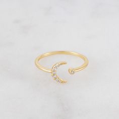 Such a cute and dainty moon ring! It's a dainty, everyday ring that is elegant, chic, and trendy. It is perfect for all ages, and as a gift. Details - Made of 925 Sterling Silver - We use a thick, durable plating of 14k Gold - Adjustable - one size fits most - Made with the highest grade of cubic zirconia stones for an authentic diamond look - Nickel-free & Hypoallergenic We ship same day, for super fast delivery! Comes in our cute packaging, ready for gift- giving! If you have any questions Minimalist Crescent Moon Charm Ring, Dainty Adjustable Moon-shaped Midi Rings, Dainty Adjustable Moon Shape Midi Rings, Adjustable Moon-shaped Stackable Rings For Promise, Dainty Moon-shaped Midi Rings As Gift, Dainty Crescent Rings For Promise, Dainty Moon-shaped Midi Promise Rings, Dainty Crescent-shaped Promise Rings, Celestial Moon Midi Rings As Promise Ring