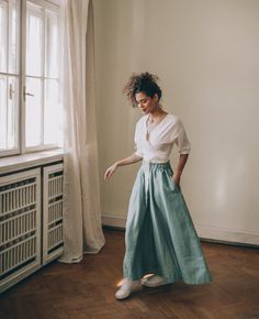 ♠ Nothing more feminine than this rich bohemian style skirt that is made of 100% pure linen. This flared midi skirt has a high rise, a waistband and side pockets. Pictured in a dusty turquoise shade here, this bohemian linen piece is available to order in multiple colors. ♠ Sizes The model on the picture is 165 cm/5'5" tall and is wearing size S. Have a look at my Size Chart below to make sure your piece will fit you best. ** Custom Orders For any changes or adjustments you may need, please cont Bohemian Green Pleated Skirt, Bohemian Maxi Skirt With Elastic Waistband And Voluminous Fit, Bohemian High Waist Maxi Skirt With Elastic, Bohemian Voluminous Maxi Skirt With Elastic Waistband, Bohemian High Waist Maxi Skirt With Elastic Waistband, Spring Bohemian Pleated Wrap Skirt, Bohemian Full Maxi Skirt For Spring, Bohemian Green Bottoms With Gathered Skirt, Peasant Style Relaxed Skirt