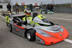 a man driving a race car on top of a track