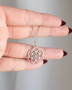 "Seed of Life - Sacred Geometry Necklace  This beautiful pendant is approx 2 x 2cm and is double sided. Choose your necklace size, 18\" Stainless Steel chain or a black waxed cotton cord at 13\", 18\" or 24\". The Seed of Life is a universal symbol of creation, found at the heart of an ancient symbol called the Flower of Life. It has been around for centuries and has captured the minds and imaginations of holy men, philosophers, and even scientists. The basis of the Seed of Life is the circle, a Silver Chain Metal Charm Necklace As Gift, Nickel Free Circular Spiritual Necklace, Adjustable Silver Necklace For Gift, Stainless Steel Circle Jewelry For Gifts, Circular Stainless Steel Jewelry Gift, Symbolic Silver Circle Necklace, Symbolic Hypoallergenic Silver Necklace, Silver Symbolic Circle Necklaces, Symbolic Silver Necklaces With Adjustable Size