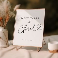 there is a sign that says sweet table in cursive writing