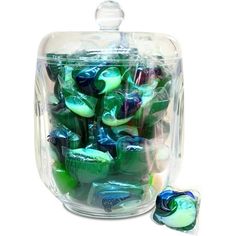 a container filled with lots of green and blue marbles